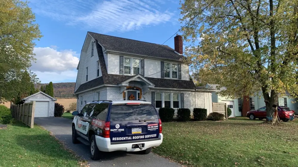 Sean's house after its new roof, with a Happy Home vehicle in the drive