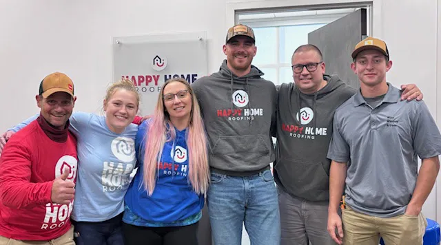 Six members of the Happy Home team in branded shirts in their office